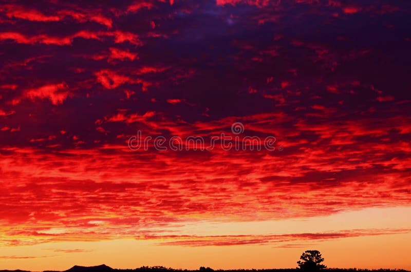 Dramatic crimson sky & storm clouds sunset