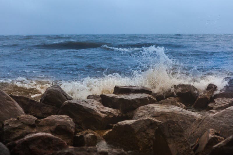Dramatic foaming splashing waves in stormy weather background stock photography