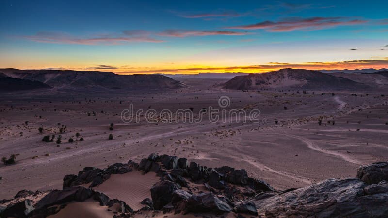 Sahara desert sunset on mountain rocks in the Moroccan part of Sahara desert