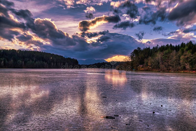 Dramatic sunset at a frozen lake royalty free stock photo