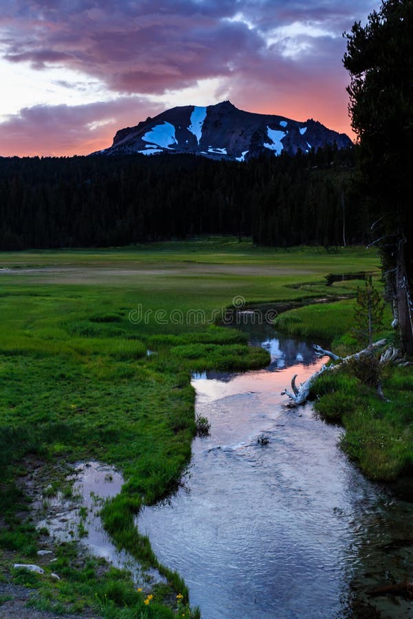 A Dramatic Pink And Purple Sunrise Over A Snow Capped Mountain Top From