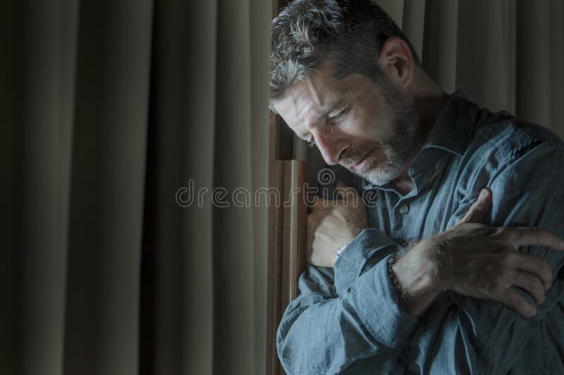 Dramatic portrait of depressed and sick man suffering from psychosis illness or mental disorder looking weird and helpless in stock photography Dramatic portrait of depressed and sick man suffering from psychosis illness or mental disorder looking weird and helpless in stock photography