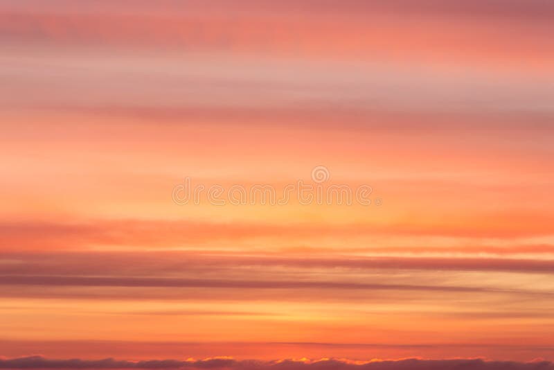 Dramatic soft sunrise, sunset orange yellow red sky with clouds background