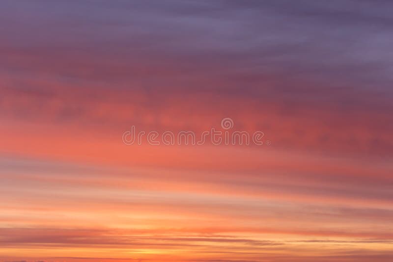 Dramatic sunrise, sunset orange pink violet sky with clouds background texture