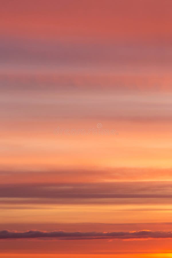 Dramatic sunrise, sunset orange yellow red sky with clouds background texture