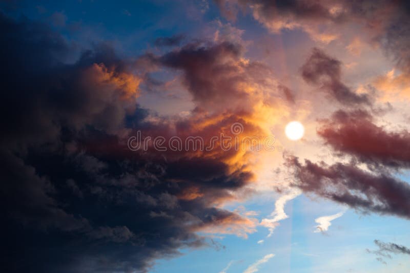 Dramatic sunset clouds around sun