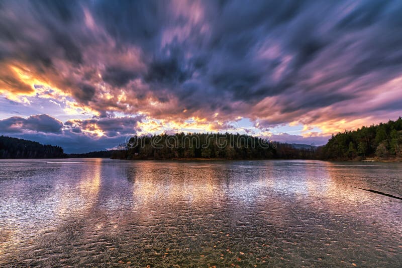 Dramatic sunset at a frozen lake stock photos