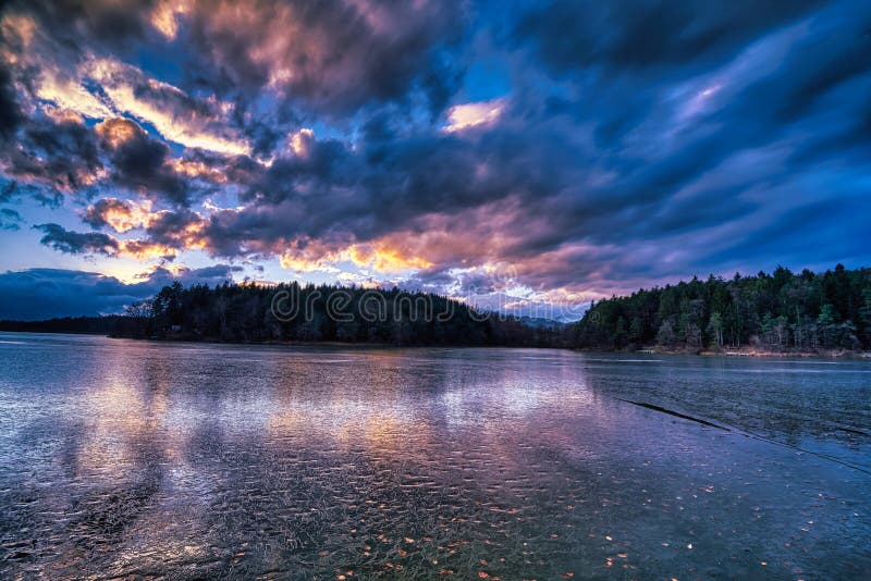 Dramatic sunset at a frozen lake royalty free stock images