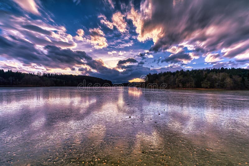 Dramatic sunset at a frozen lake stock photo