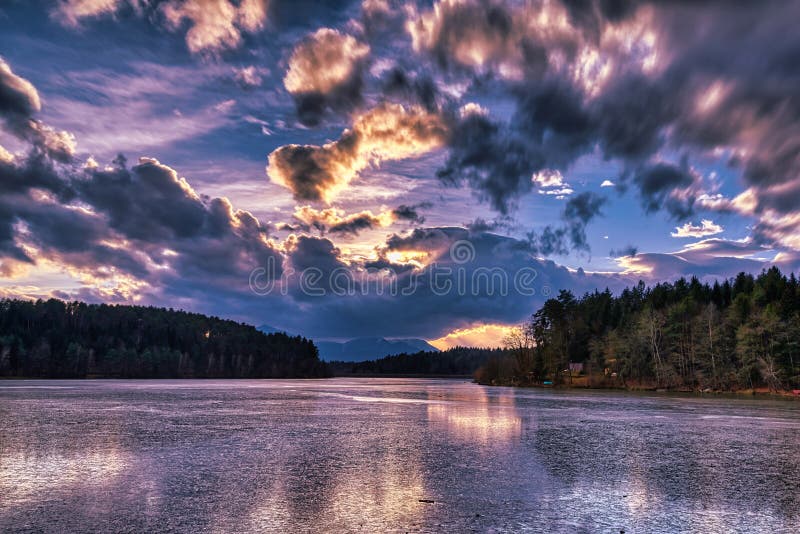 Dramatic sunset at a frozen lake stock photo