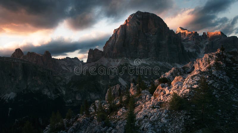 Dramatic sunset in the mountains with dark heavy clouds in Dolomite Mountains Italy royalty free stock photo