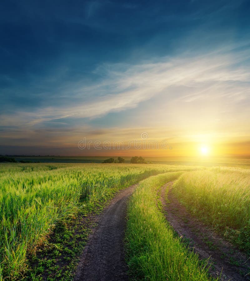 Dramatic sunset over dirty road stock images