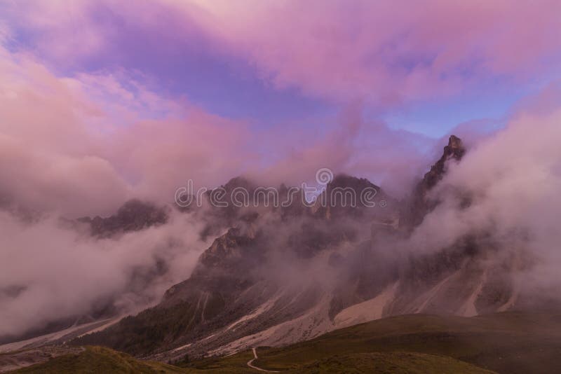 Dramatic scenery in the Dolomite Alps, Italy, in summer, with storm clouds and majestic peaks