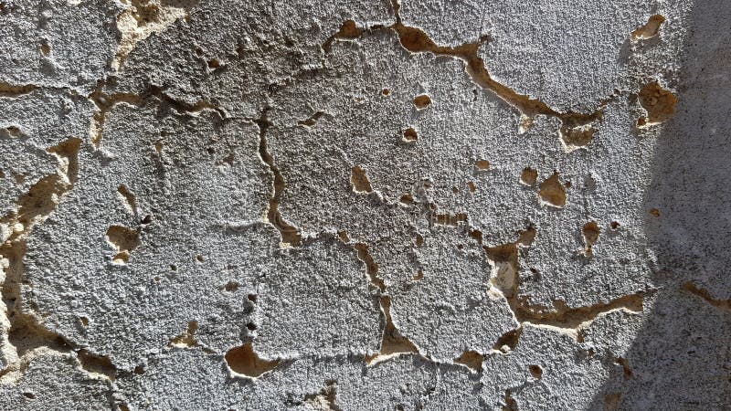 Dramatic texture of dark grey cement wall with rippled deep cracks royalty free stock photos