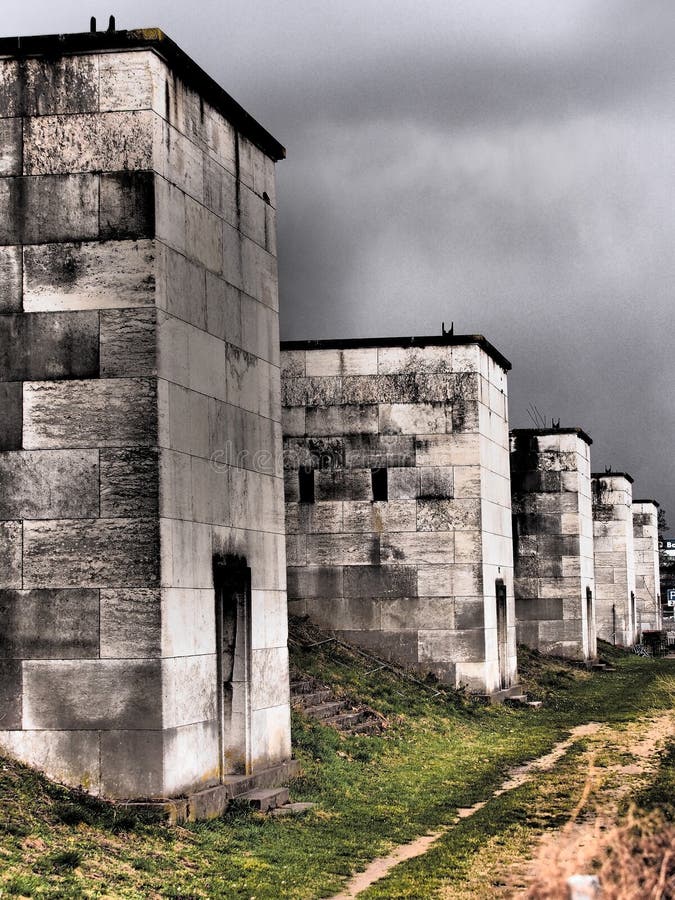 Nuremberg, Germany - 2015, April 2: Dramatic view along the defunct west side light towers of the former Nazi Party rally grounds called Zeppelin field. Nuremberg, Germany - 2015, April 2: Dramatic view along the defunct west side light towers of the former Nazi Party rally grounds called Zeppelin field.