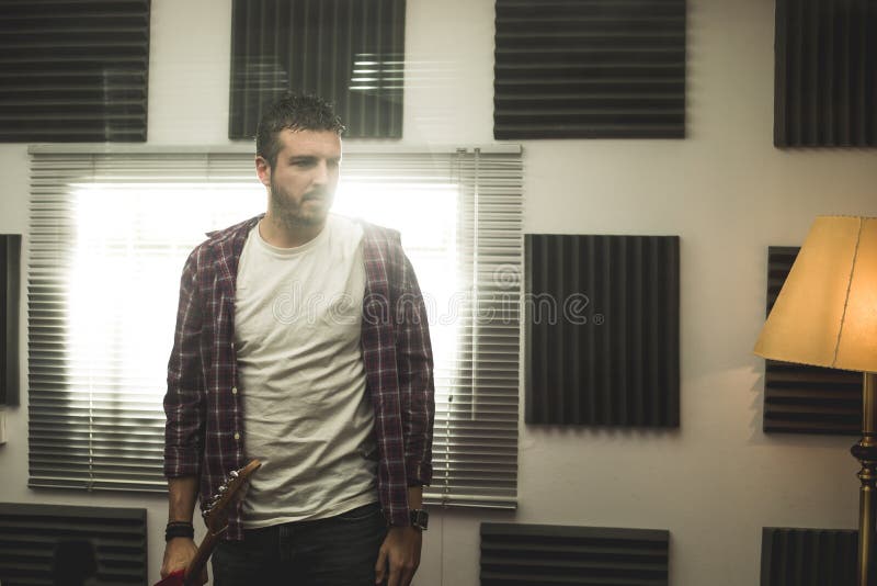 Dramatisch portret van een mens die een gitaar spelen Gitarist stock fotografie Dramatisch portret van een mens die een gitaar spelen Gitarist stock fotografie