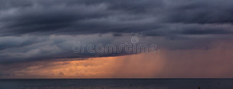 Dramatic Panoramic View of a cloudscape over the Ocean during a dark, rainy and colorful morning sunrise. Taken over Beach Ancon in Trinidad, Cuba. Dramatic Panoramic View of a cloudscape over the Ocean during a dark, rainy and colorful morning sunrise. Taken over Beach Ancon in Trinidad, Cuba.