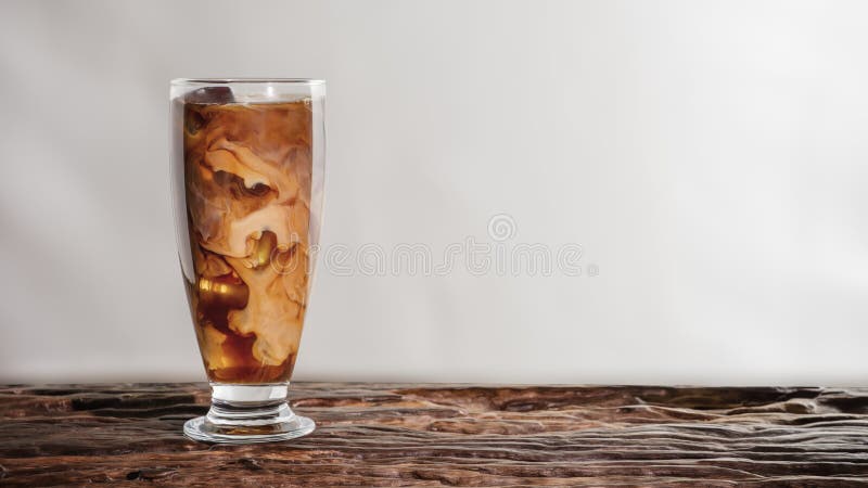 Dranken achtergrond van een glas koude-melkkoffie op houten tafel met witte achtergrond stock fotografie Dranken achtergrond van een glas koude-melkkoffie op houten tafel met witte achtergrond stock fotografie
