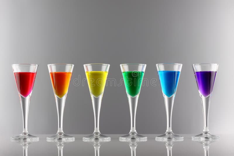 A row of drinks in rainbow colours. A row of drinks in rainbow colours
