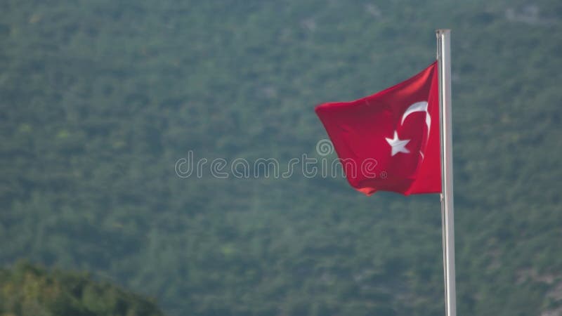 Drapeau national turc agitant au vent en arrière-plan.