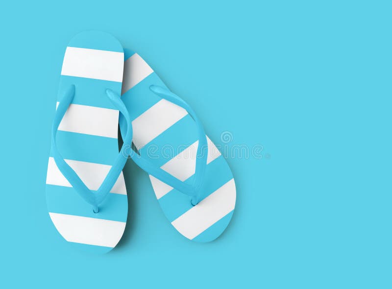 Top view of summer beach light blue flip flop on azure background sea holiday vacation and travel concept. Top view of summer beach light blue flip flop on azure background sea holiday vacation and travel concept