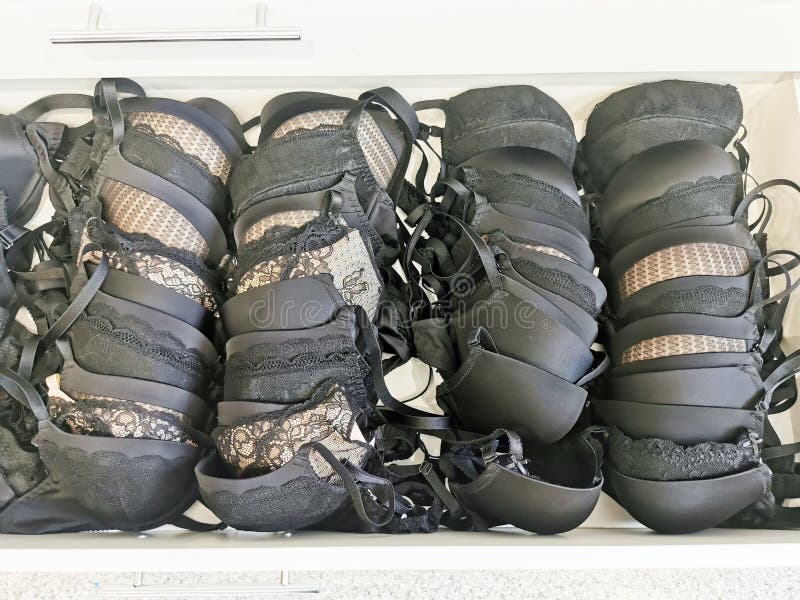 Ladies` Lacy Black Lingerie in Store Drawers. Storage of Bras with