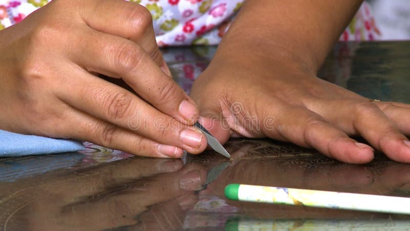 Drawing patterns with a pointed metal on a surface stock footage