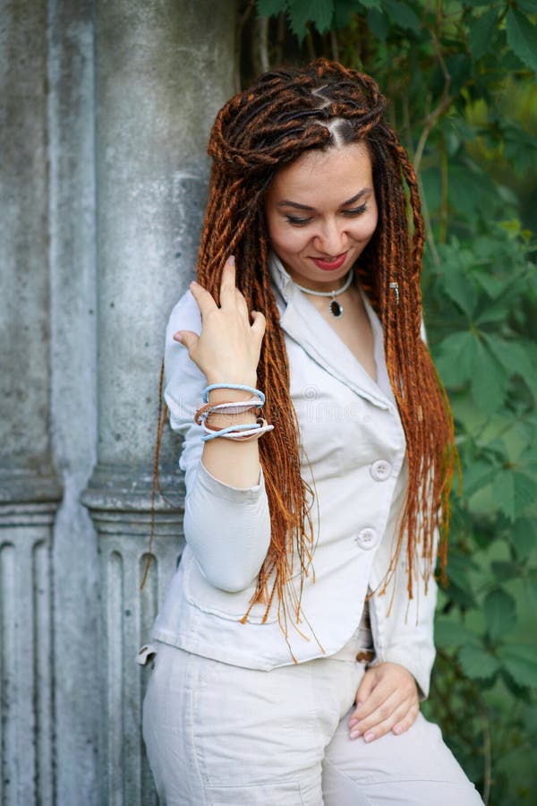 Dreadlocks fashionable girl dressed in white posing near retro columns royalty free stock photos Dreadlocks fashionable girl dressed in white posing near retro columns royalty free stock photos
