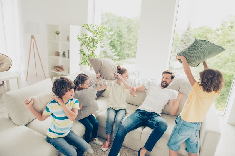 Dream, dreamy funky dad day concept. Portrait of stylish family with one parent spend free time play on couch in apartment with light bright modern living room