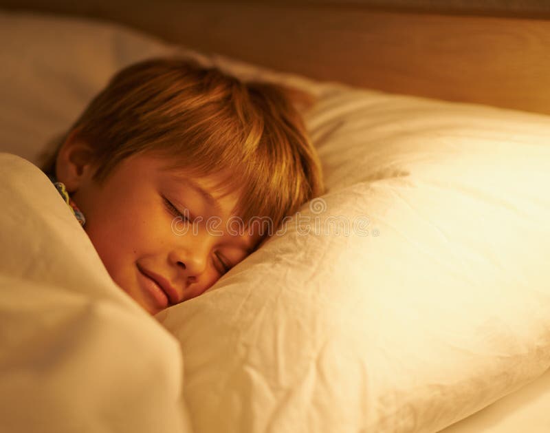 Dream a Happy Little Dream. a Young Boy Sleeping in Bed. Stock Image