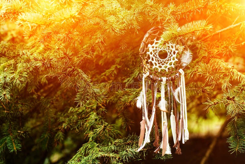 Dreamcatcher, american native amulet on sunset. Shaman