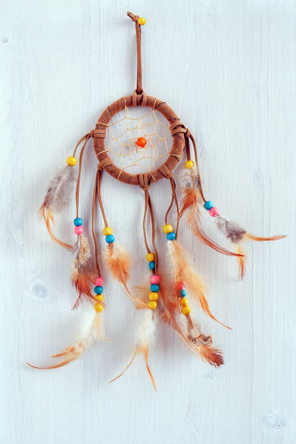 Dreamcatcher, american native amulet on wooden background. Shaman symbol royalty free stock photo