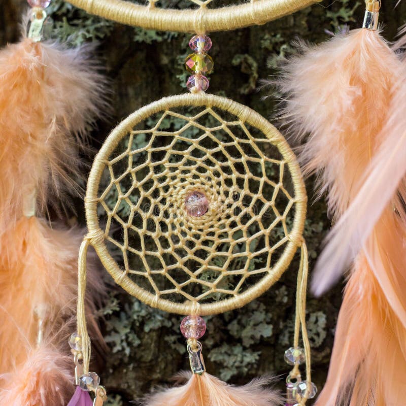 Dreamcatcher made of feathers, leather, beads, and ropes stock photo