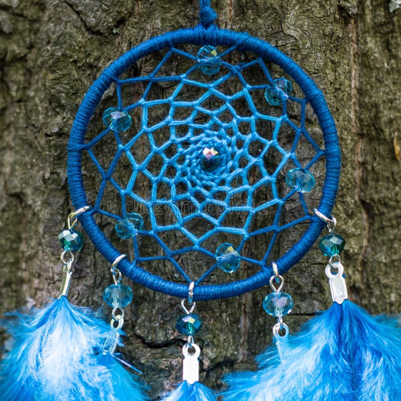 Dreamcatcher made of feathers, leather, beads, and ropes stock image