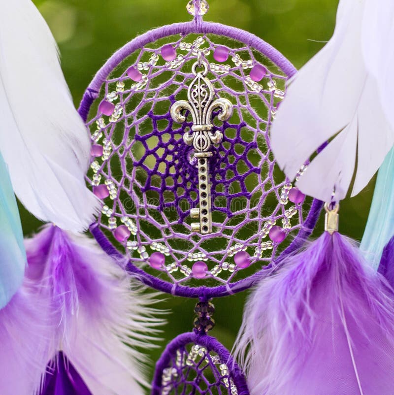 Dreamcatcher made of feathers, leather, beads, and ropes royalty free stock photos