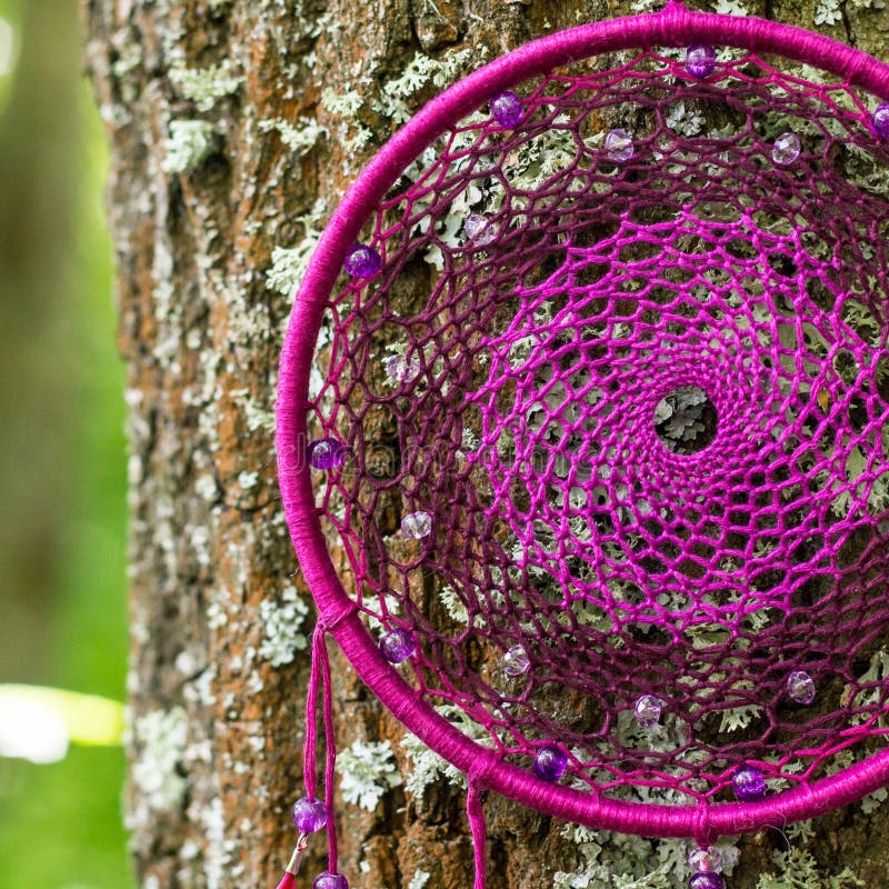 Dreamcatcher made of feathers, leather, beads, and ropes stock photos