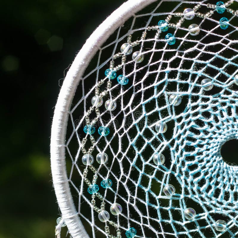 Dreamcatcher made of feathers, leather, beads, and ropes stock photo