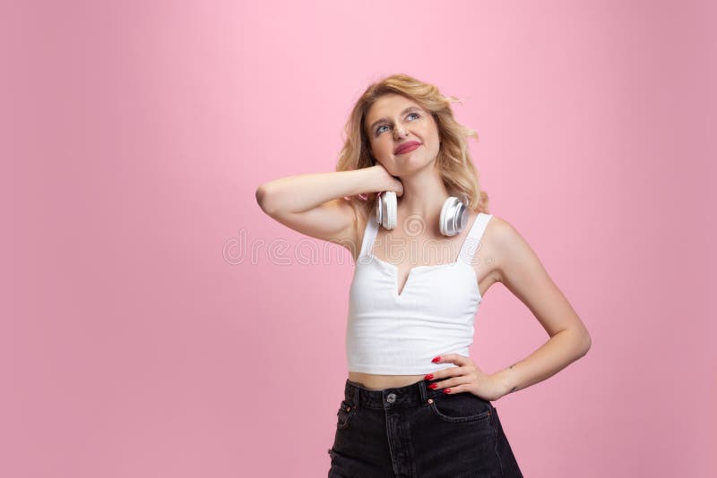 Caucasian young woman`s portrait isolated on pink studio background. Beautiful female model. Concept of human emotions