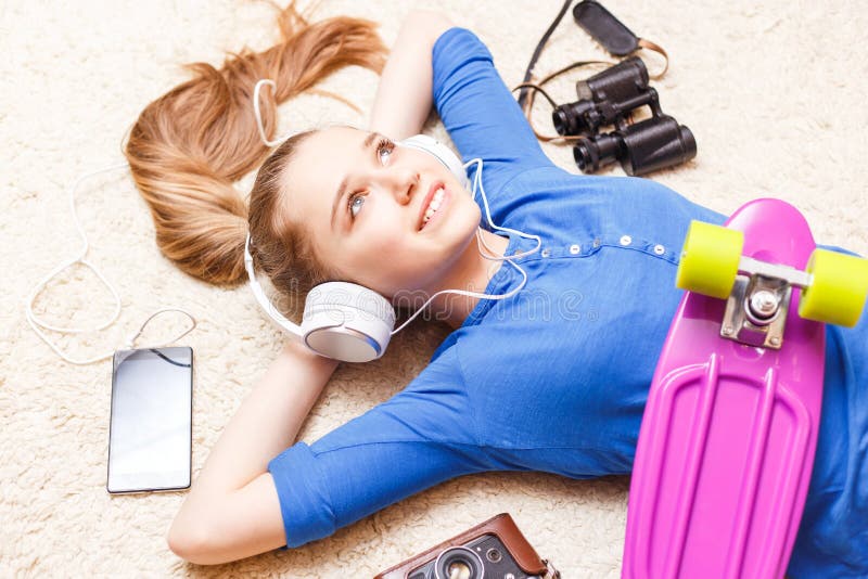 Dreaming cheerful teenage girl lying on the floor royalty free stock photos Dreaming cheerful teenage girl lying on the floor royalty free stock photos