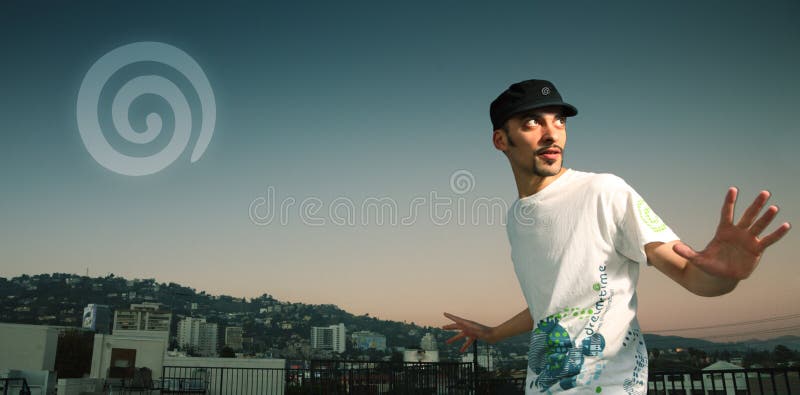 Young men in Dreamstime t-shirt with Hollywood Hills and rising Dreamstime logo on the background. Young men in Dreamstime t-shirt with Hollywood Hills and rising Dreamstime logo on the background.