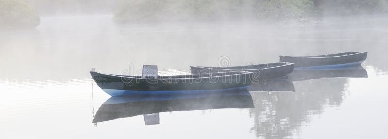 Dreamy boat scene banner in fog and golden sun for tranquility calm peace and mindfulness yoga