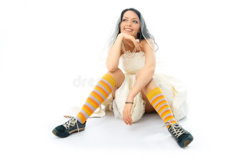 Dreamy bride wearing running shoes and socks