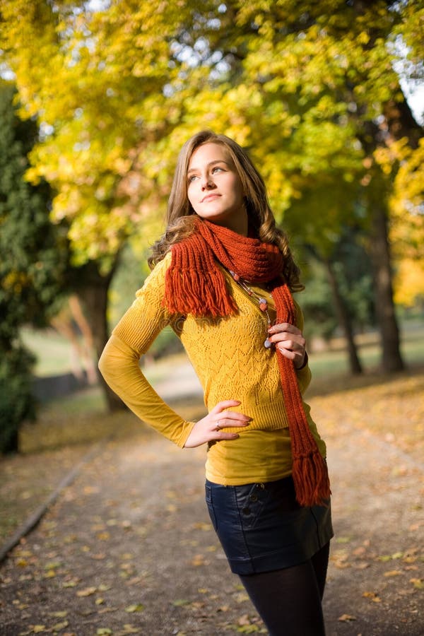 Half length portrait of dreamy fall fashion girl in colorful clothes.