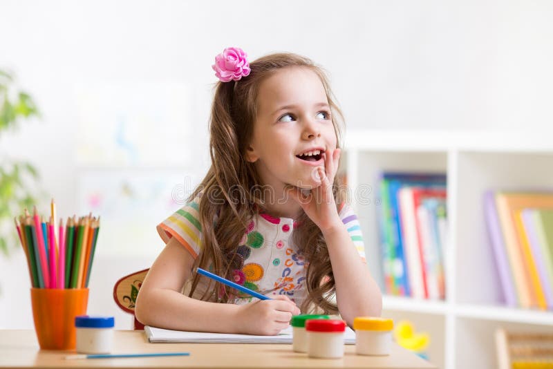 Dreamy kid girl with pencils