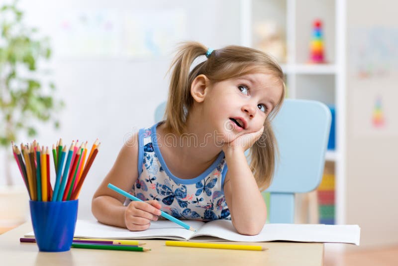 Dreamy kid girl with pencils