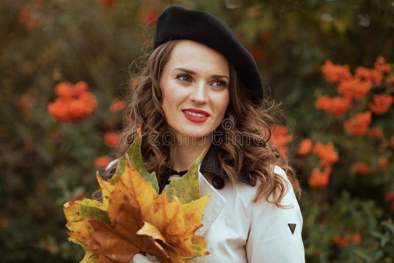 Dreamy Young Woman in Beige Trench Coat and Black Beret Stock Photo ...