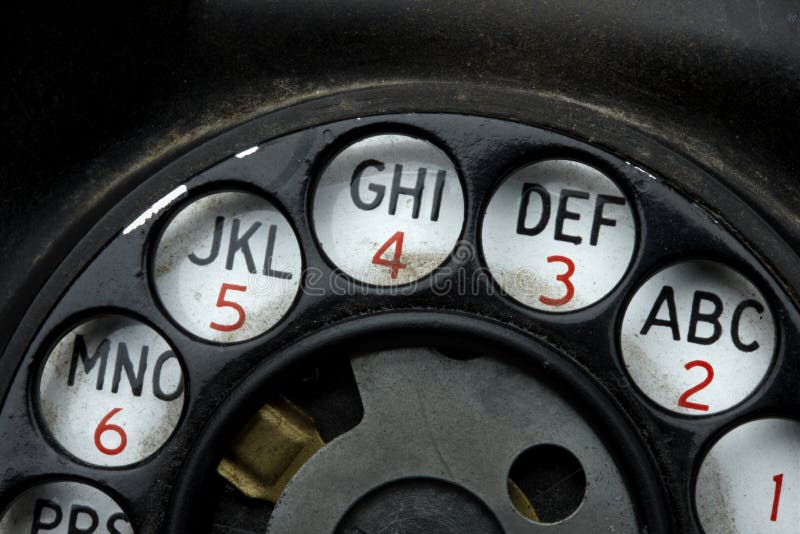 Macro shot rotary dial on grungy, old telephone. Macro shot rotary dial on grungy, old telephone