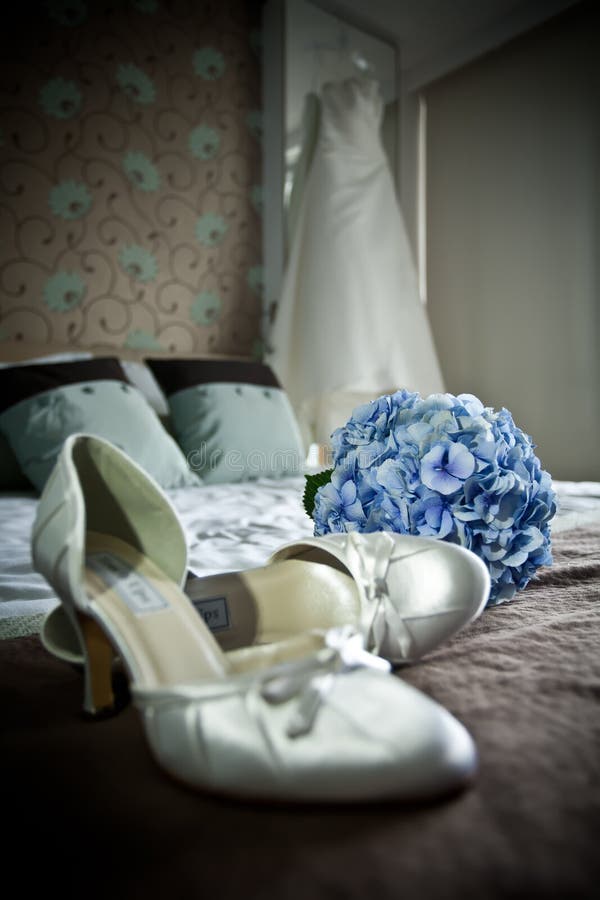 White shoes and dress. Blue bouquet. White shoes and dress. Blue bouquet.