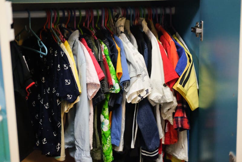 Dressing closet with clothes arranged on hangers