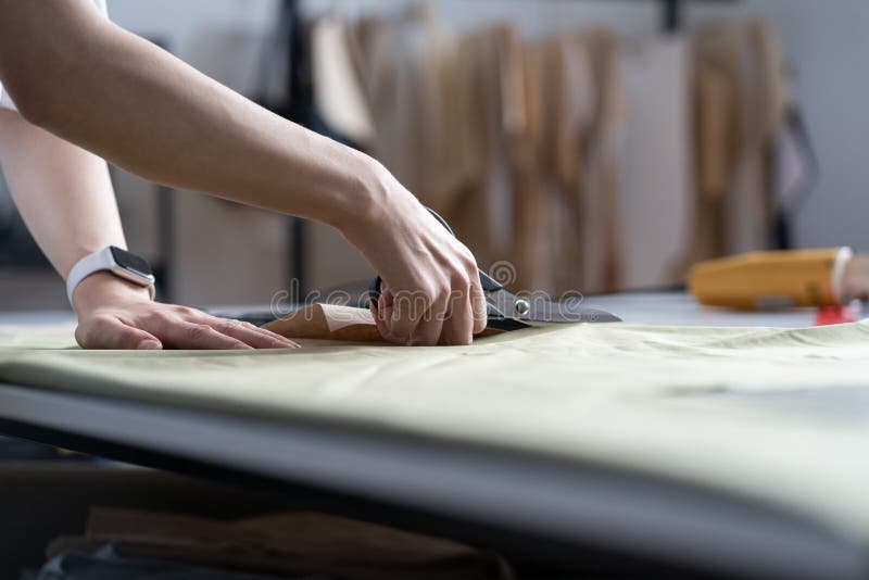 Dressmaker Hand Use Scissors Cut Fabric Material To Sew. Closeup of